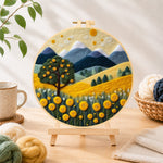 Finished golden harvest tree and mountains needle felting displayed on a wooden easel