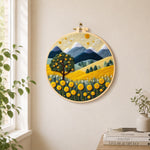Golden harvest tree and mountains needle felt wall art displayed in a bright home interior