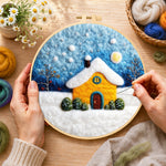 Creating the golden snowy house under starry sky wool painting by hand with a felting needle