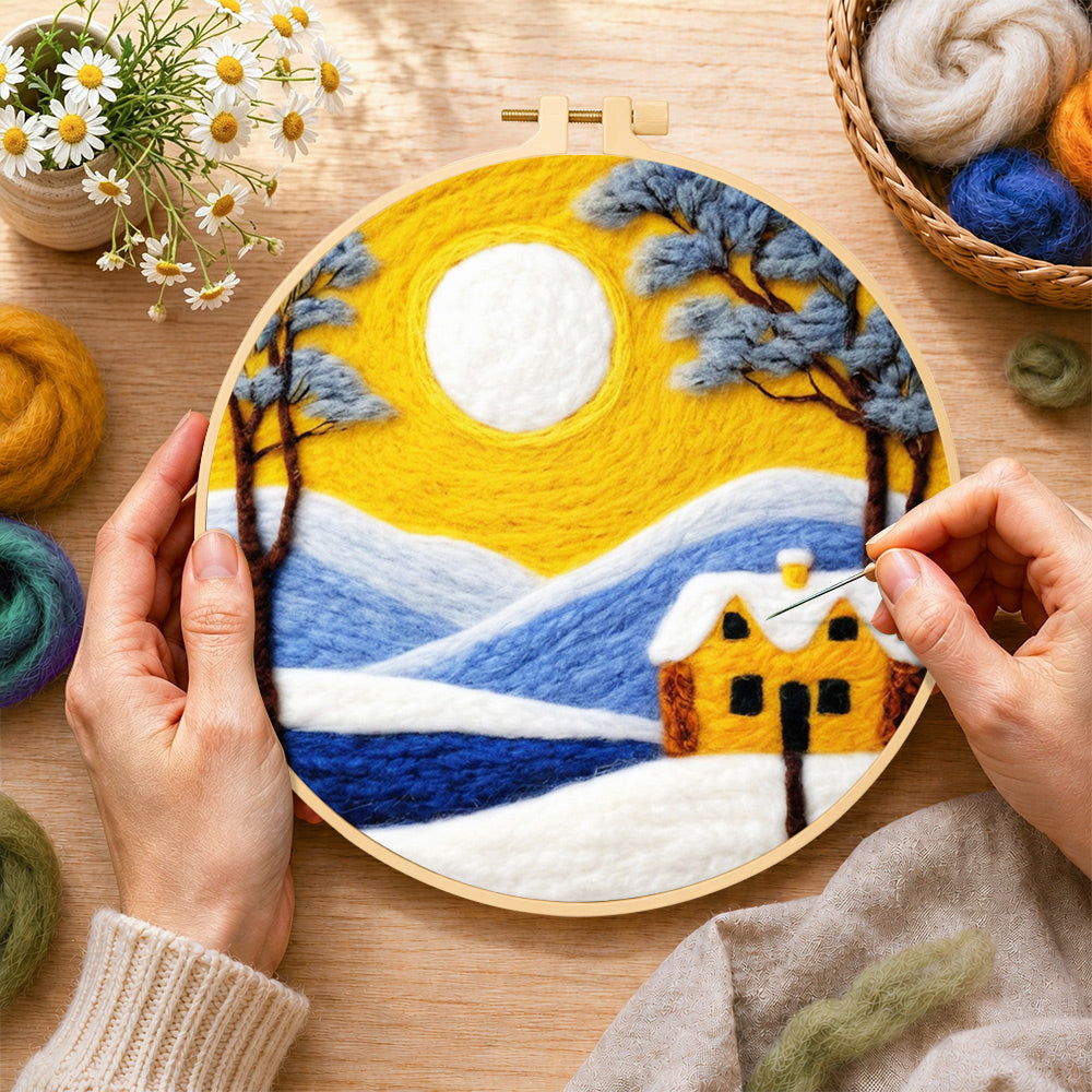 Creating the golden sun and blue mountain snowscape wool painting by hand with a felting needle