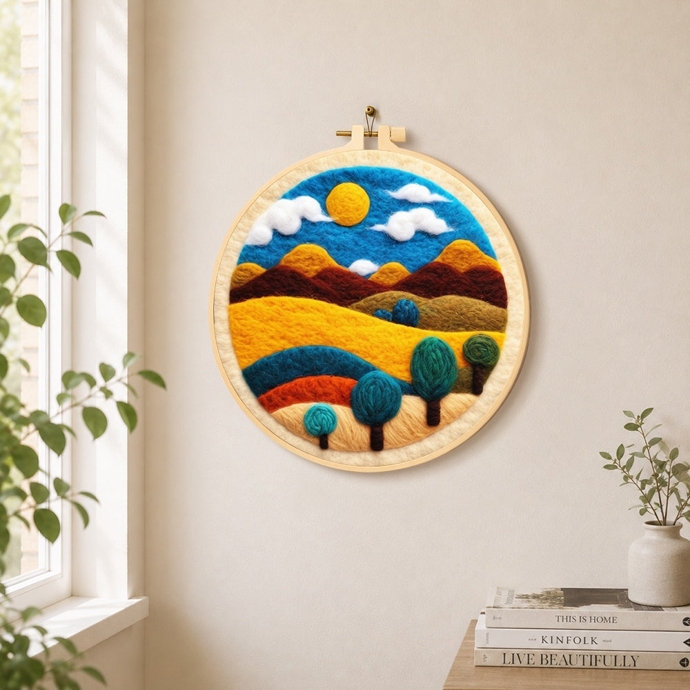 Golden sun and swirling tree hills needle felt wall art displayed in a bright home interior