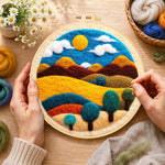 Creating the golden sun and swirling tree hills wool painting by hand with a felting needle