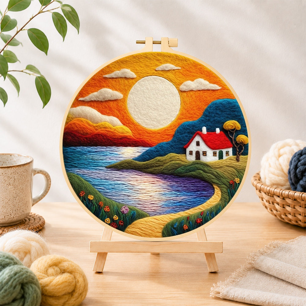 Finished golden sunset and tranquil lake needle felting displayed on a wooden easel