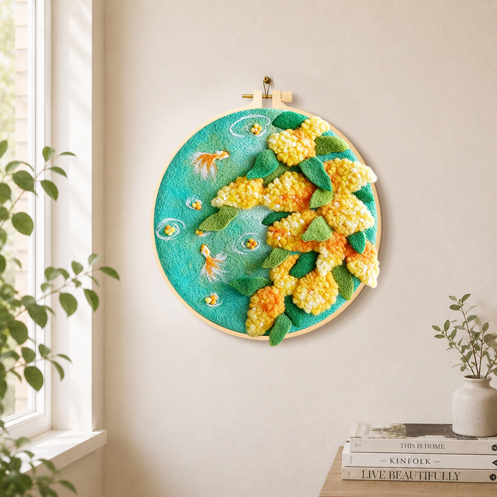 Goldfish with yellow plants needle felt wall art displayed in a bright home interior