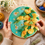 Creating the goldfish with yellow plants wool painting by hand with a felting needle