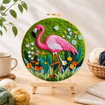 Finished graceful pink flamingo and wildflowers needle felting displayed on a wooden easel