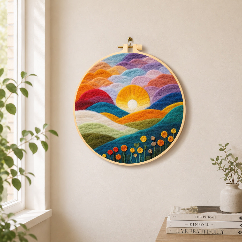 Gradient clouds, bright yellow sunset and colourful hills needle felt wall art displayed in a bright home interior