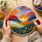 Creating the gradient clouds, bright yellow sunset and colourful hills wool painting by hand with a felting needle