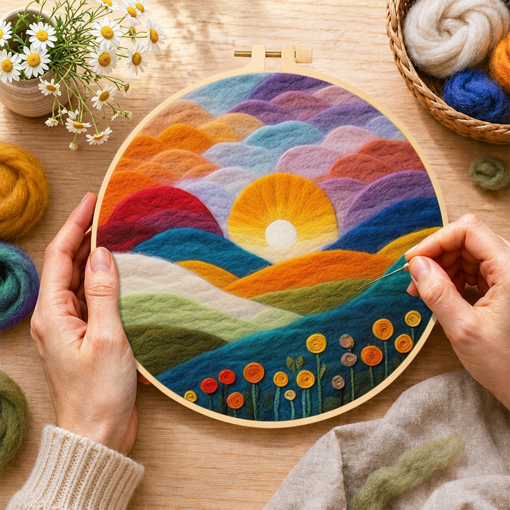 Creating the gradient clouds, bright yellow sunset and colourful hills wool painting by hand with a felting needle