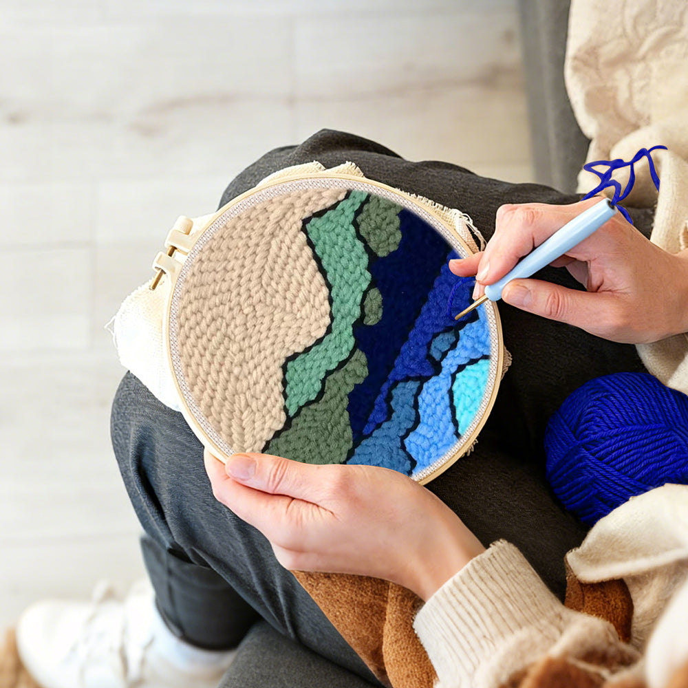 Creating handmade green and blue mountain range punch needle artwork