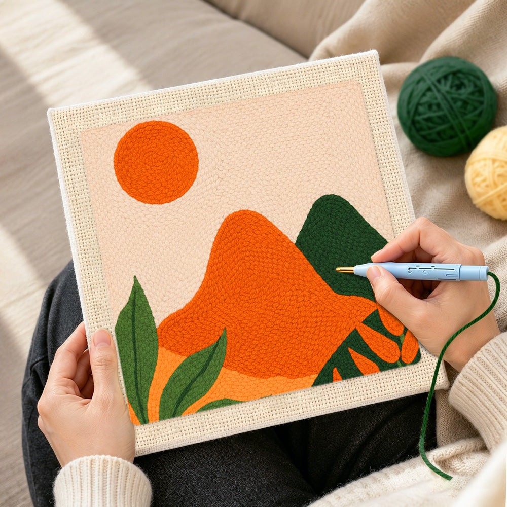 Creating handmade green and orange hills with leaves punch needle artwork