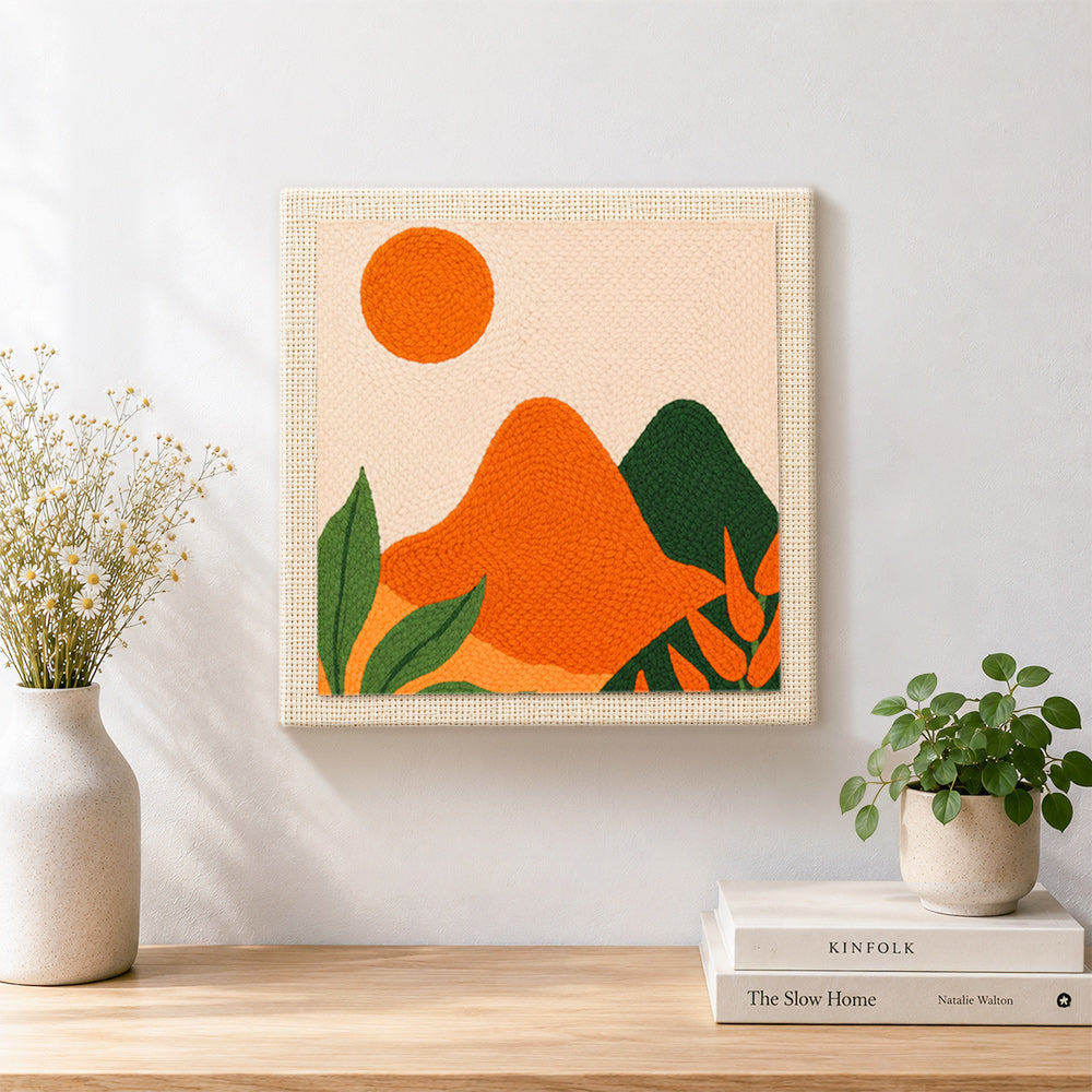 Finished green and orange hills with leaves artwork displayed on a wall