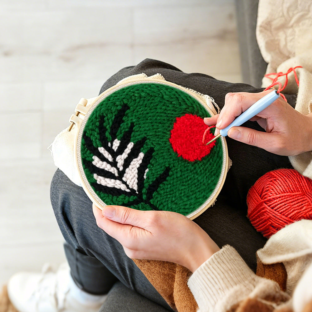 Creating handmade green botanical with red sun punch needle artwork