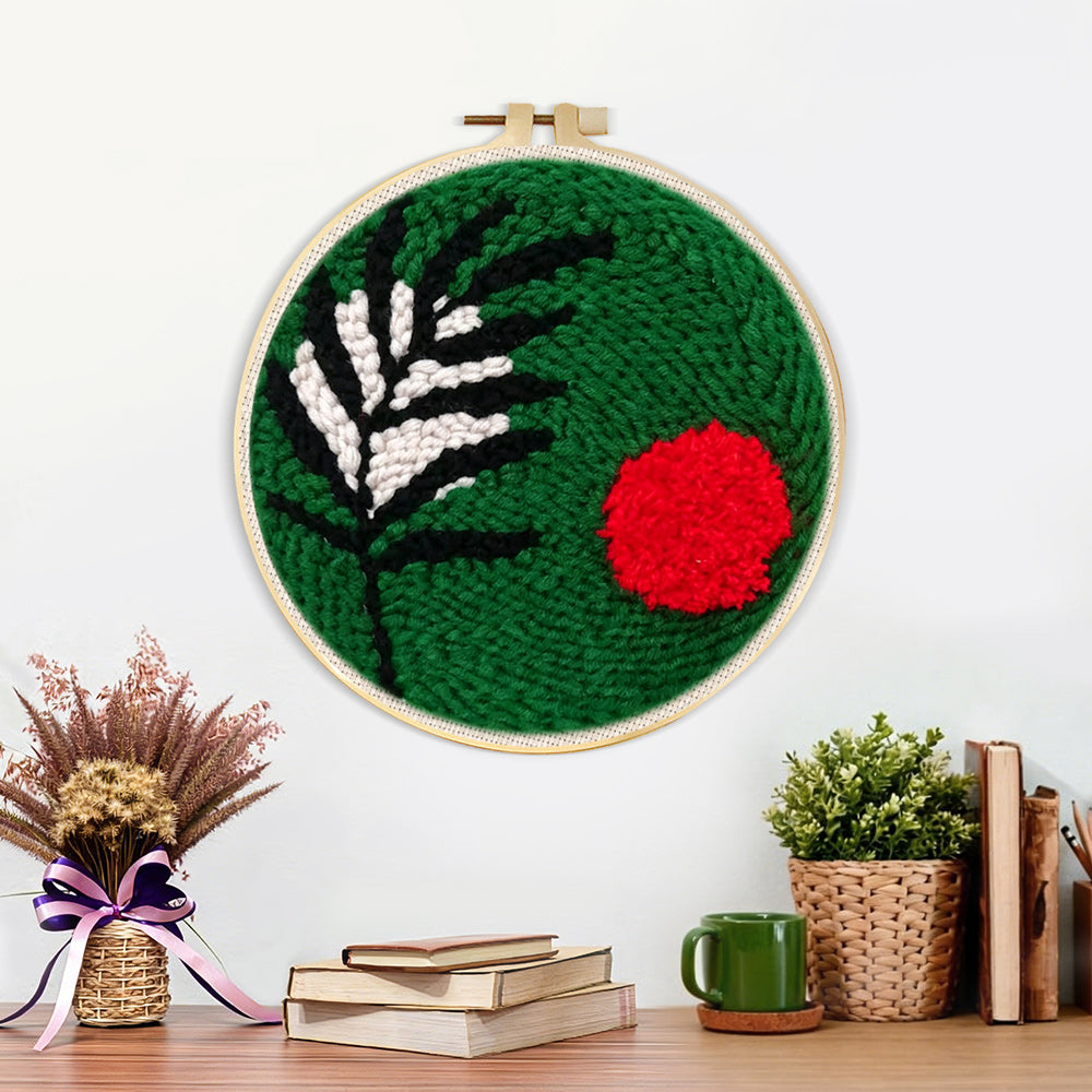 Finished green botanical with red sun artwork displayed on a wall