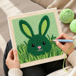 Creating handmade green bunny hiding in grass punch needle artwork