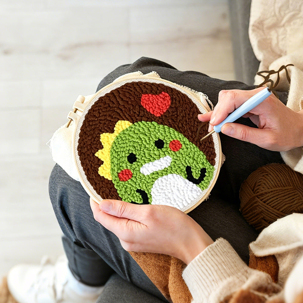 Creating handmade green dinosaur and red heart punch needle artwork