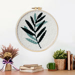 Finished green fern leaf artwork displayed on a wall