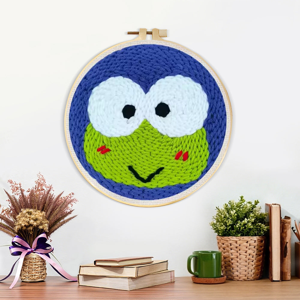 Finished green frog with big eyes artwork displayed on a wall