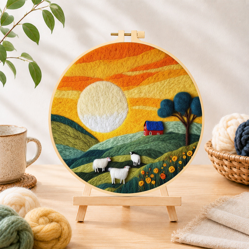 Finished green hills and fluffy sheep under golden sunset needle felting displayed on a wooden easel