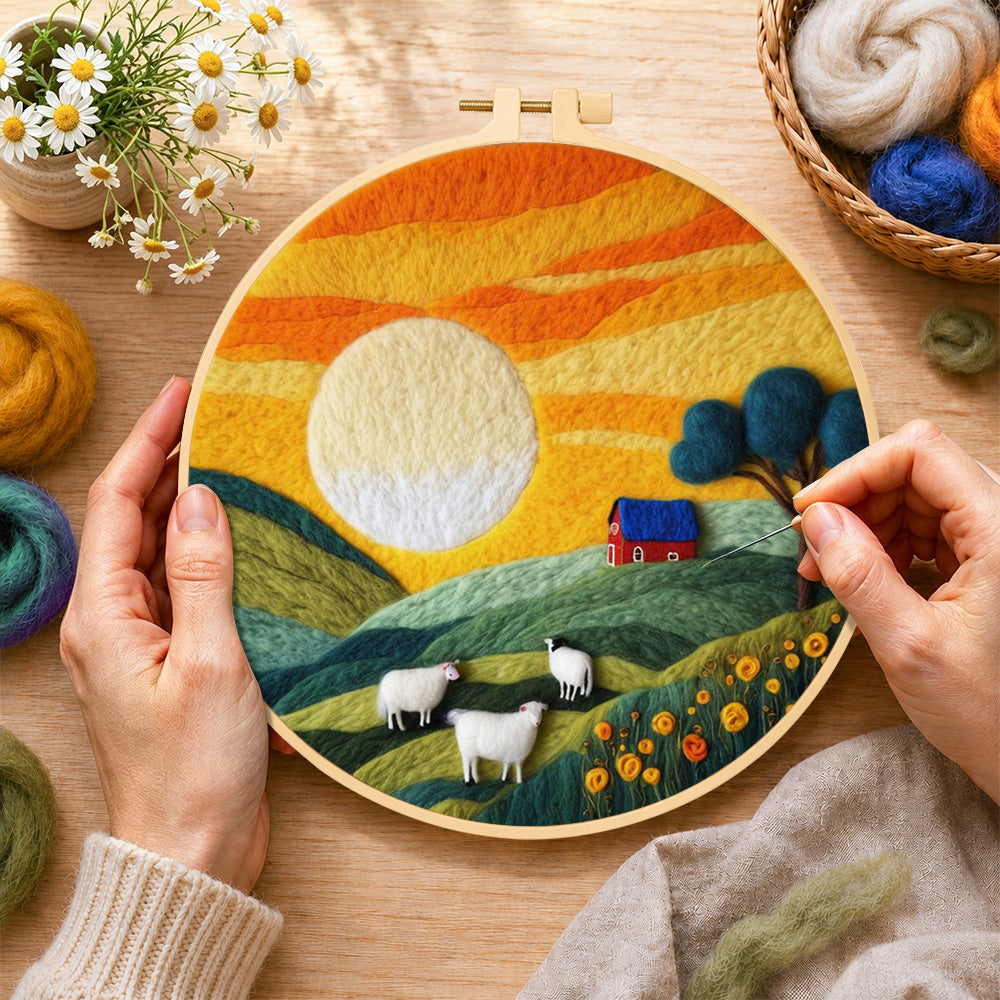 Creating the green hills and fluffy sheep under golden sunset wool painting by hand with a felting needle
