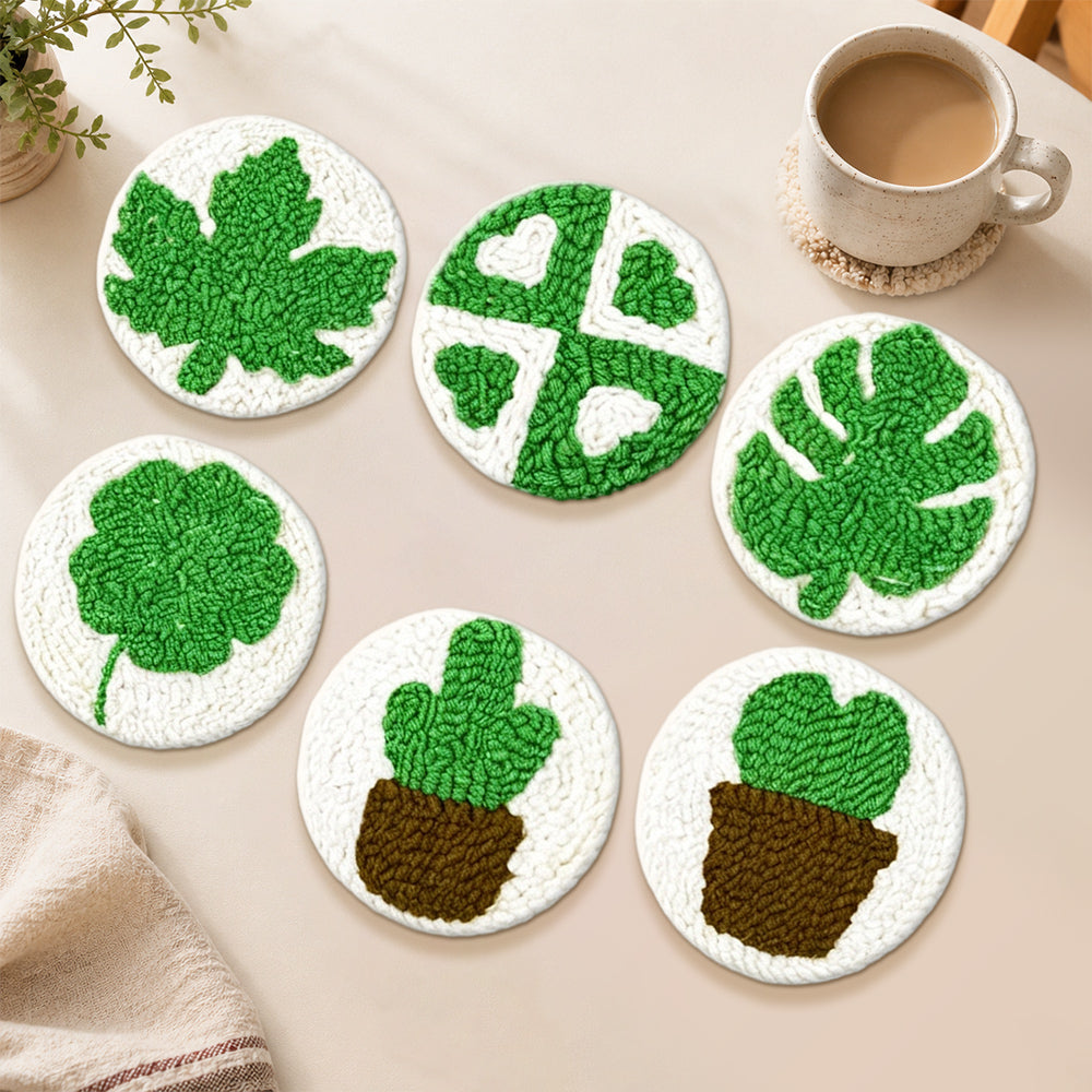 Green monstera and cactus punch needle coasters used for home decoration