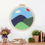 Finished green mountains in spring artwork displayed on a wall