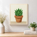 Finished green succulent in terracotta pot artwork displayed on a wall