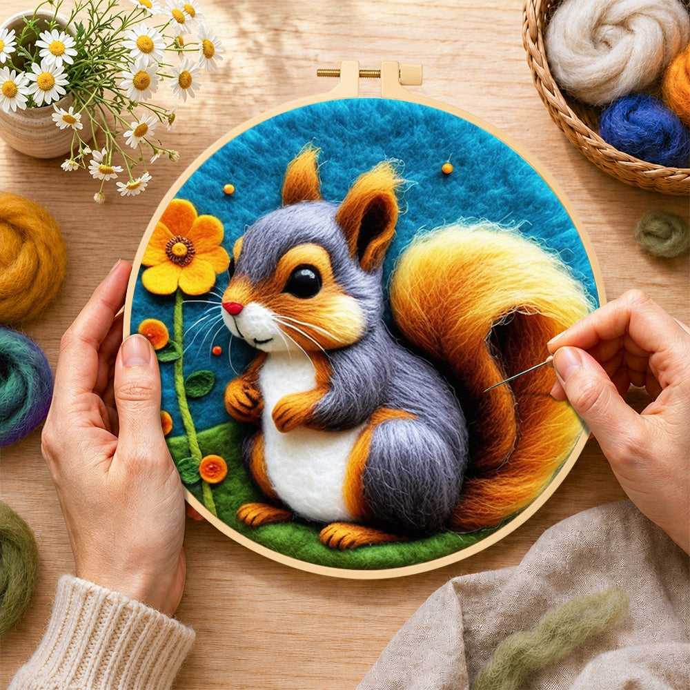 Creating the grey and orange squirrel with golden tail wool painting by hand with a felting needle