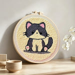 Grey kitten punch needle artwork displayed on a table