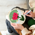 Creating handmade growing red flower punch needle artwork