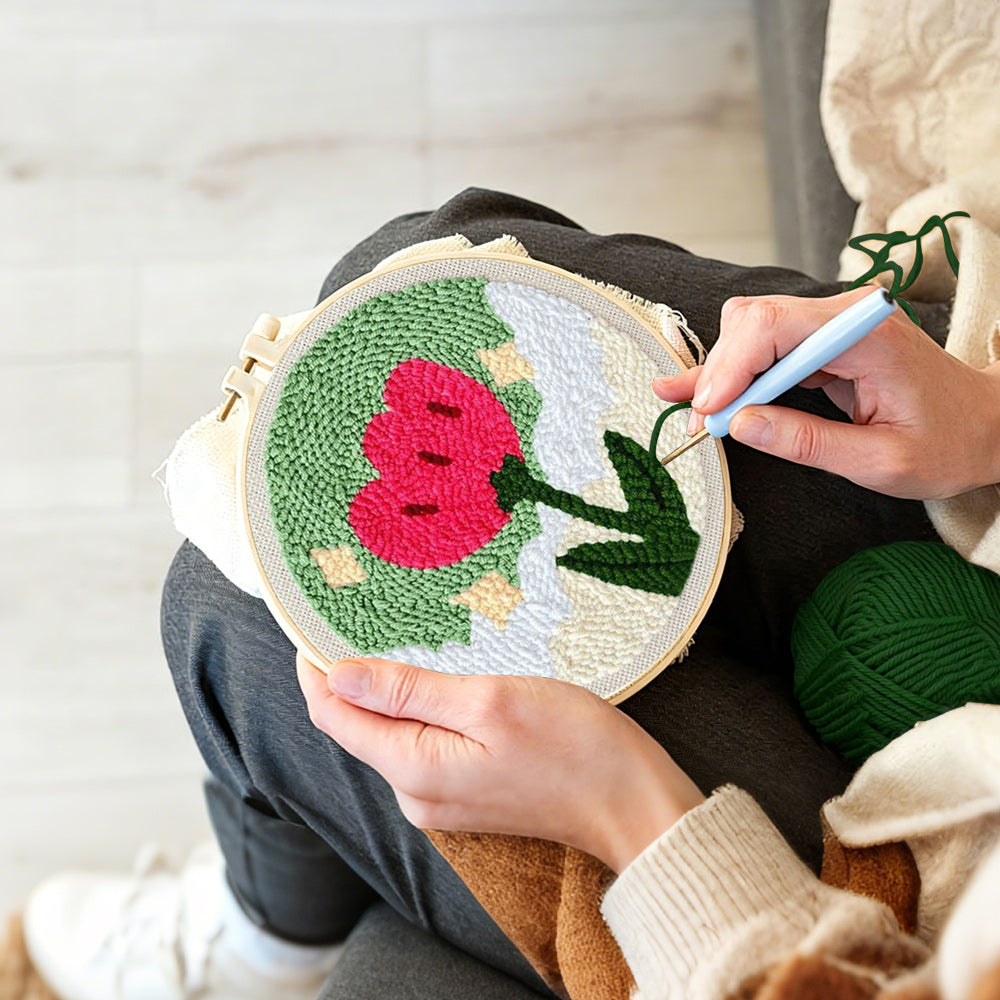 Creating handmade growing red flower punch needle artwork