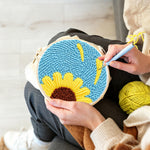 Creating handmade half sunflower on blue background punch needle artwork