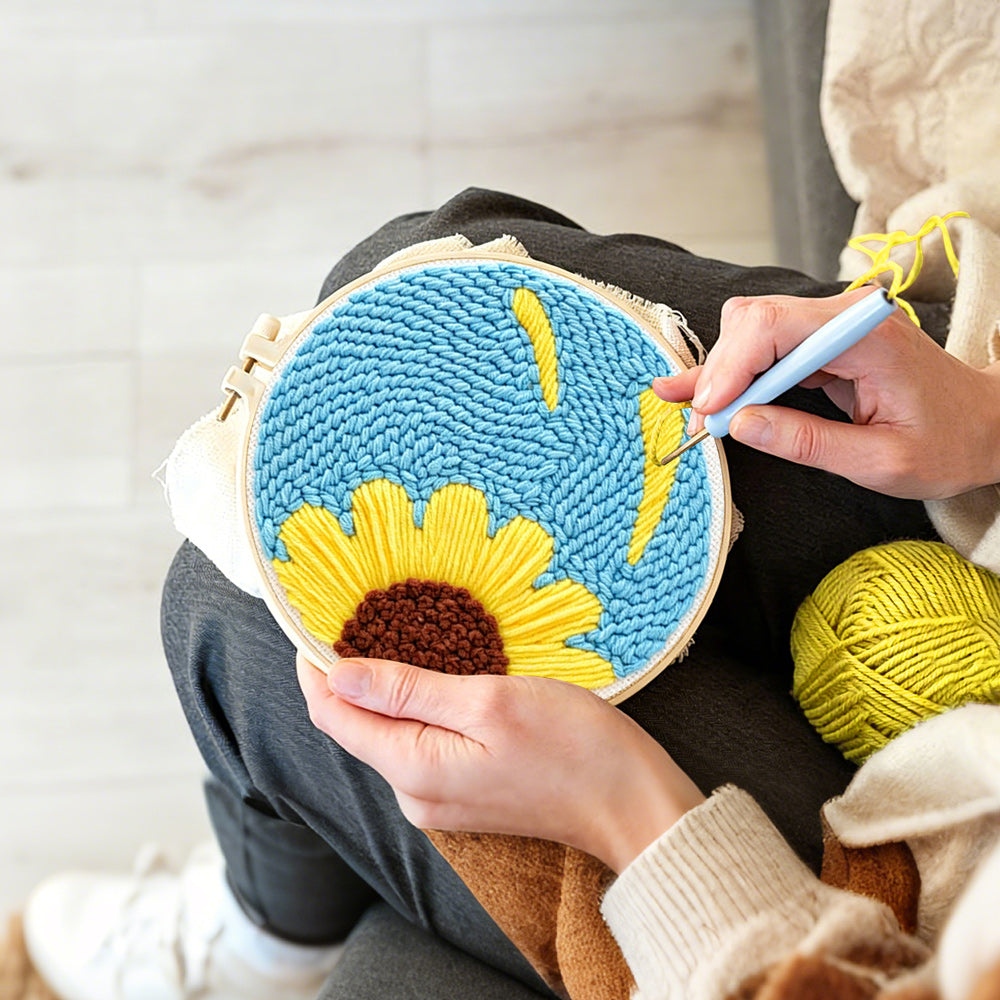 Creating handmade half sunflower on blue background punch needle artwork