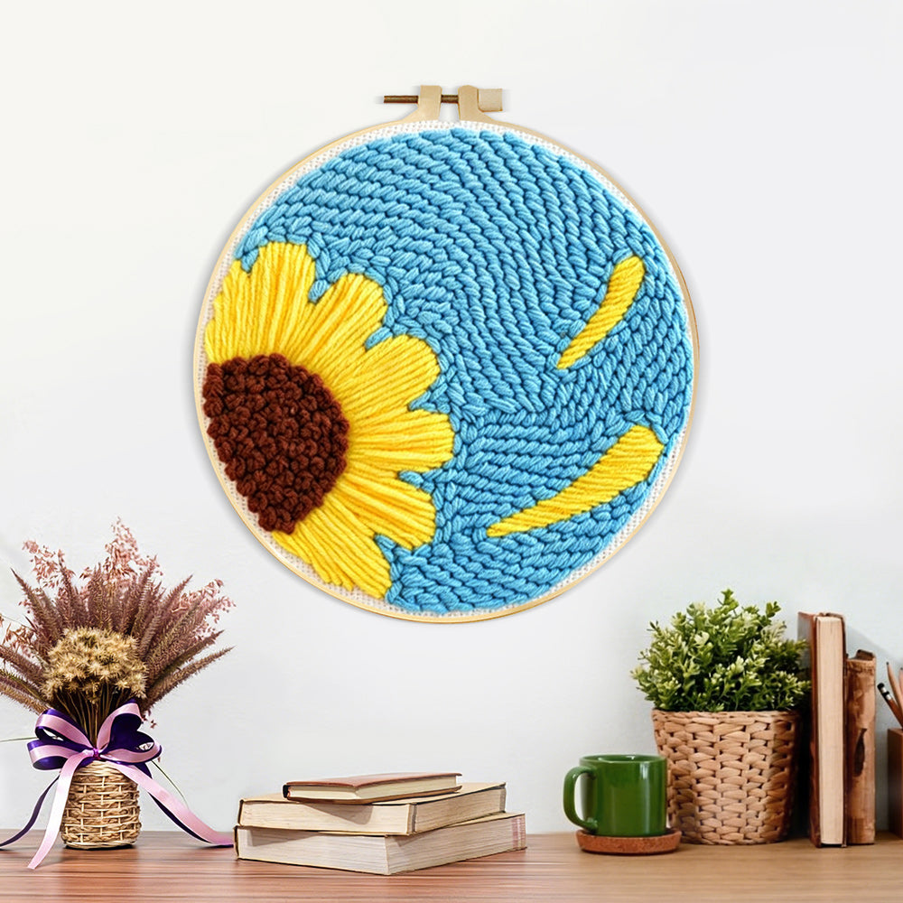 Finished half sunflower on blue background artwork displayed on a wall