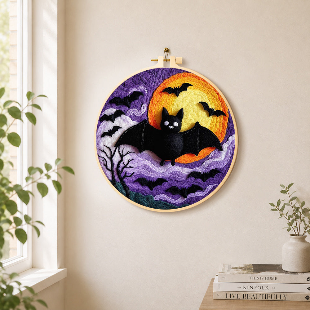 Halloween bats and spooky swirling clouds needle felt wall art displayed in a bright home interior