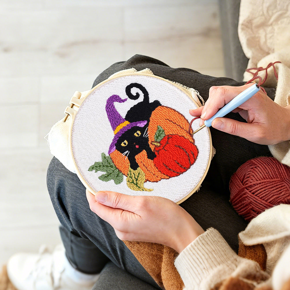 Creating handmade halloween black cat and pumpkins punch needle artwork