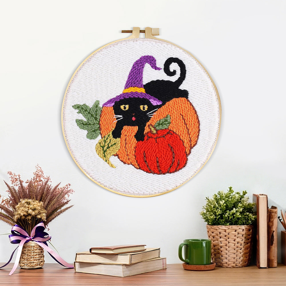 Finished halloween black cat and pumpkins artwork displayed on a wall