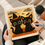 Creating handmade halloween black cats with witch hat punch needle artwork