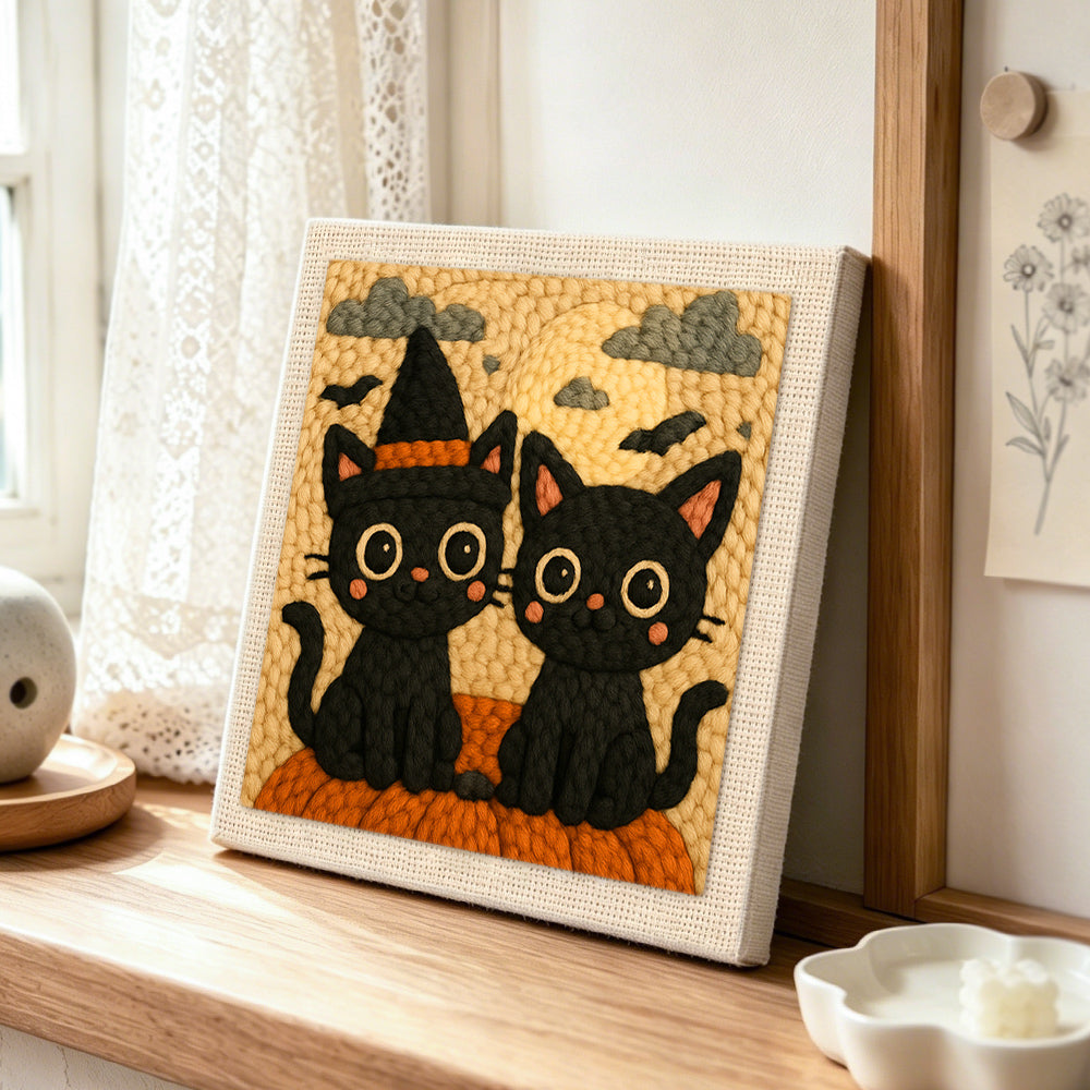 Halloween black cats with witch hat punch needle artwork displayed on a table