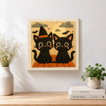 Finished halloween black cats with witch hat artwork displayed on a wall