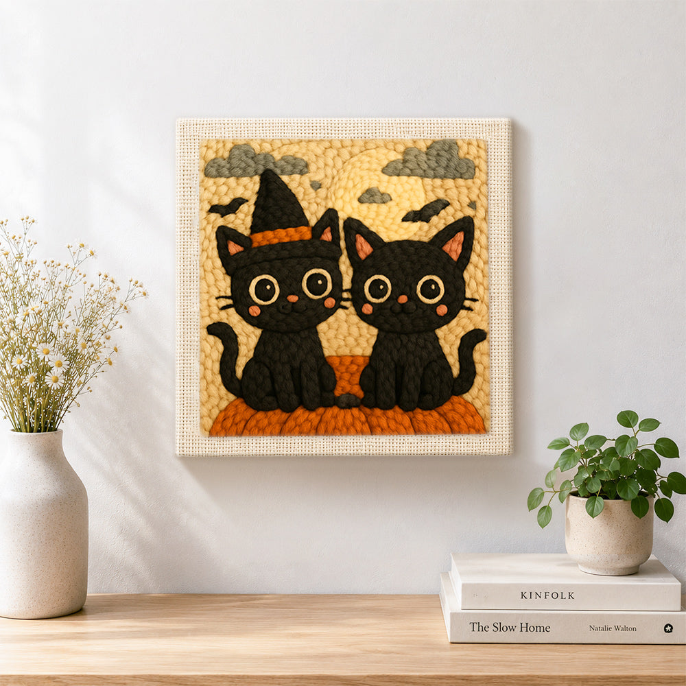 Finished halloween black cats with witch hat artwork displayed on a wall