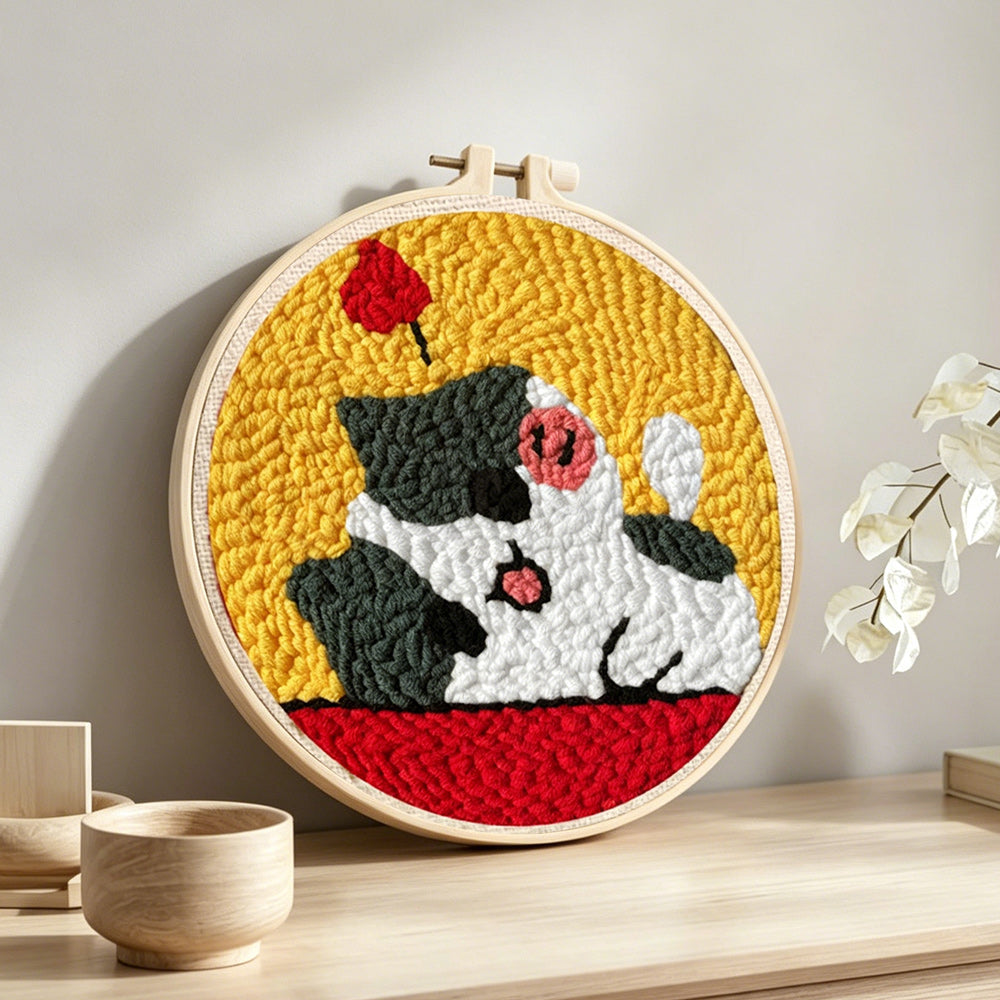 Happy and adorable cat punch needle artwork displayed on a table