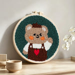Happy bear punch needle artwork displayed on a table