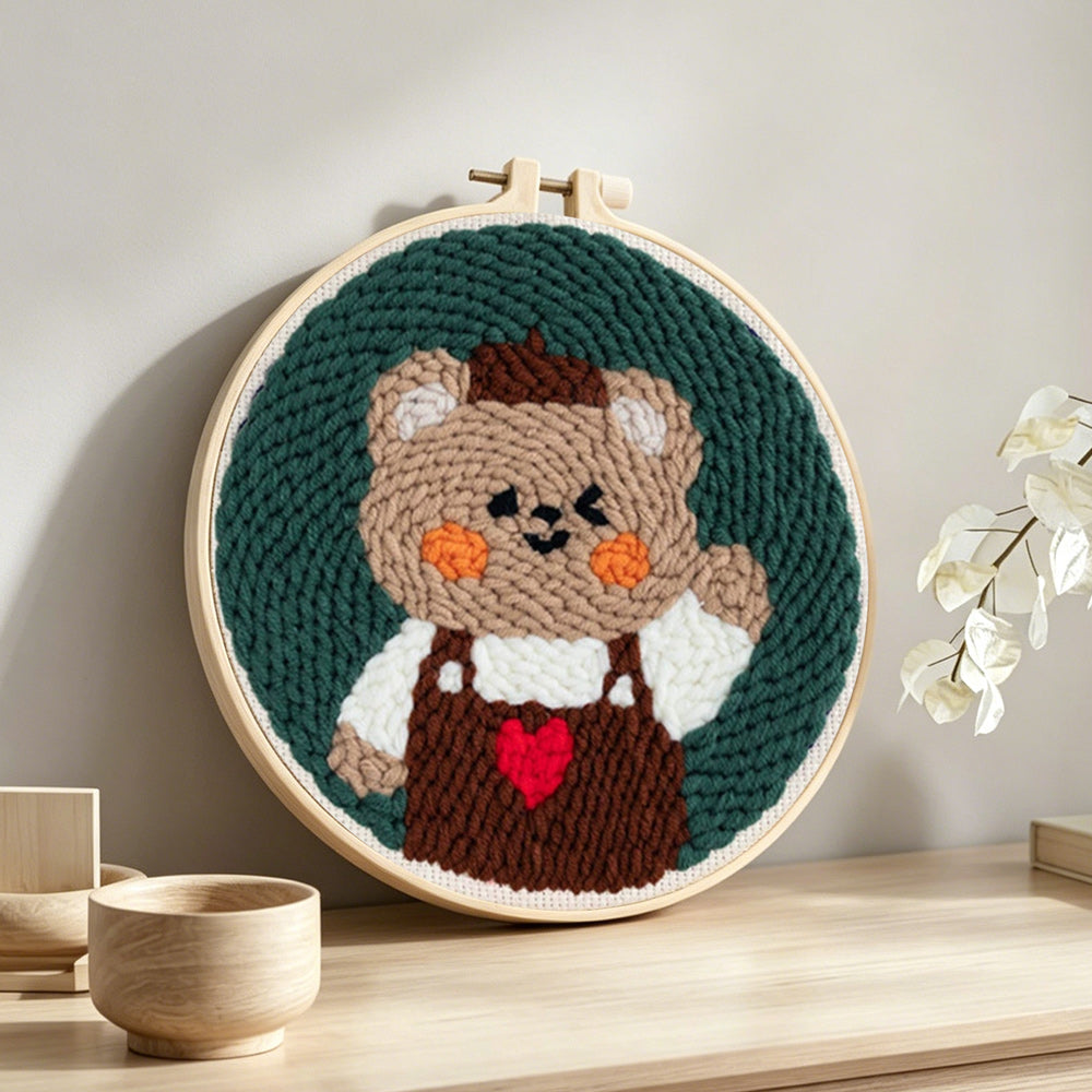 Happy bear punch needle artwork displayed on a table