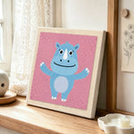Happy blue rhino with open arms punch needle artwork displayed on a table