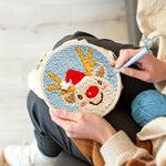 Creating handmade happy christmas reindeer punch needle artwork