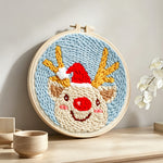 Happy christmas reindeer punch needle artwork displayed on a table