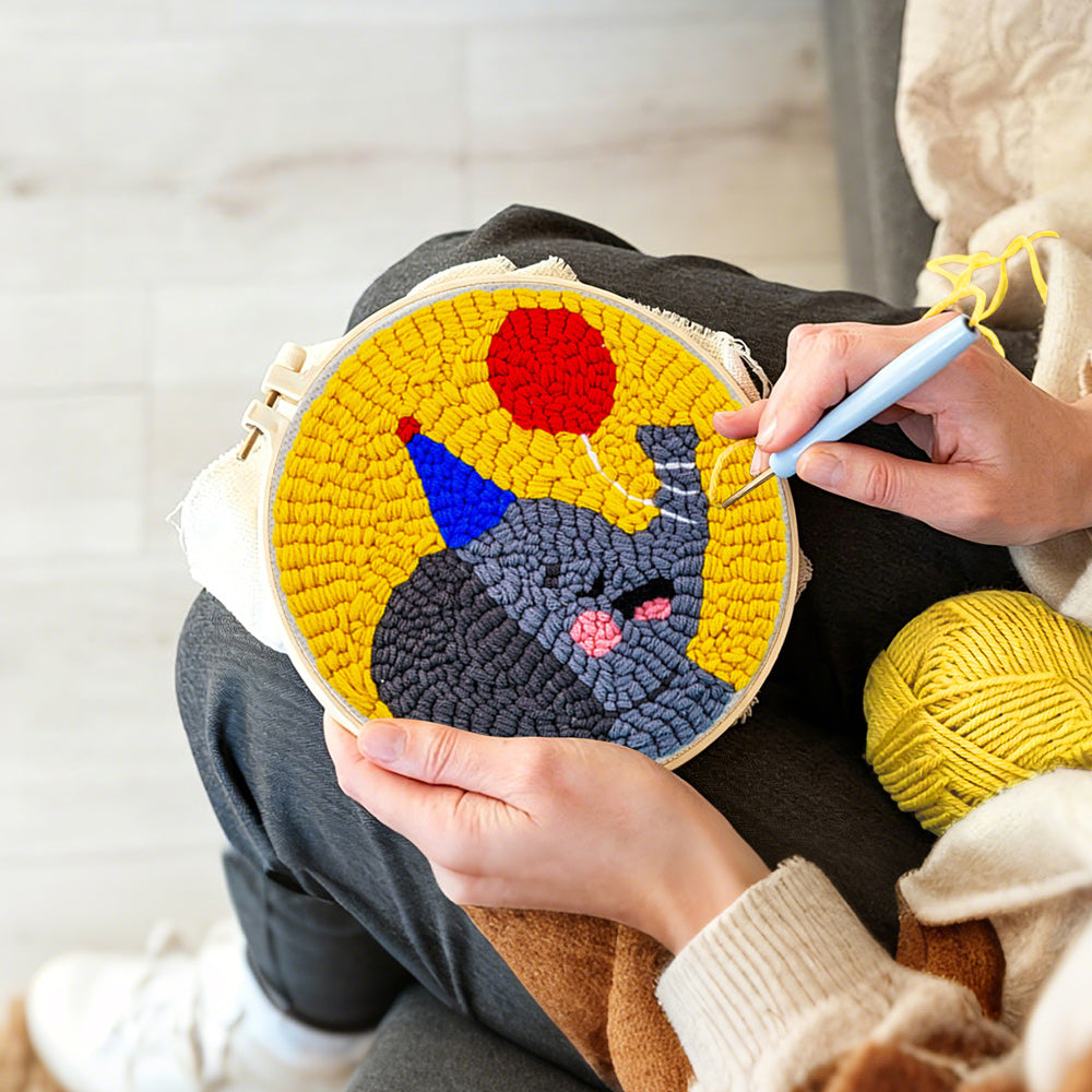Creating handmade happy elephant with a red balloon punch needle artwork