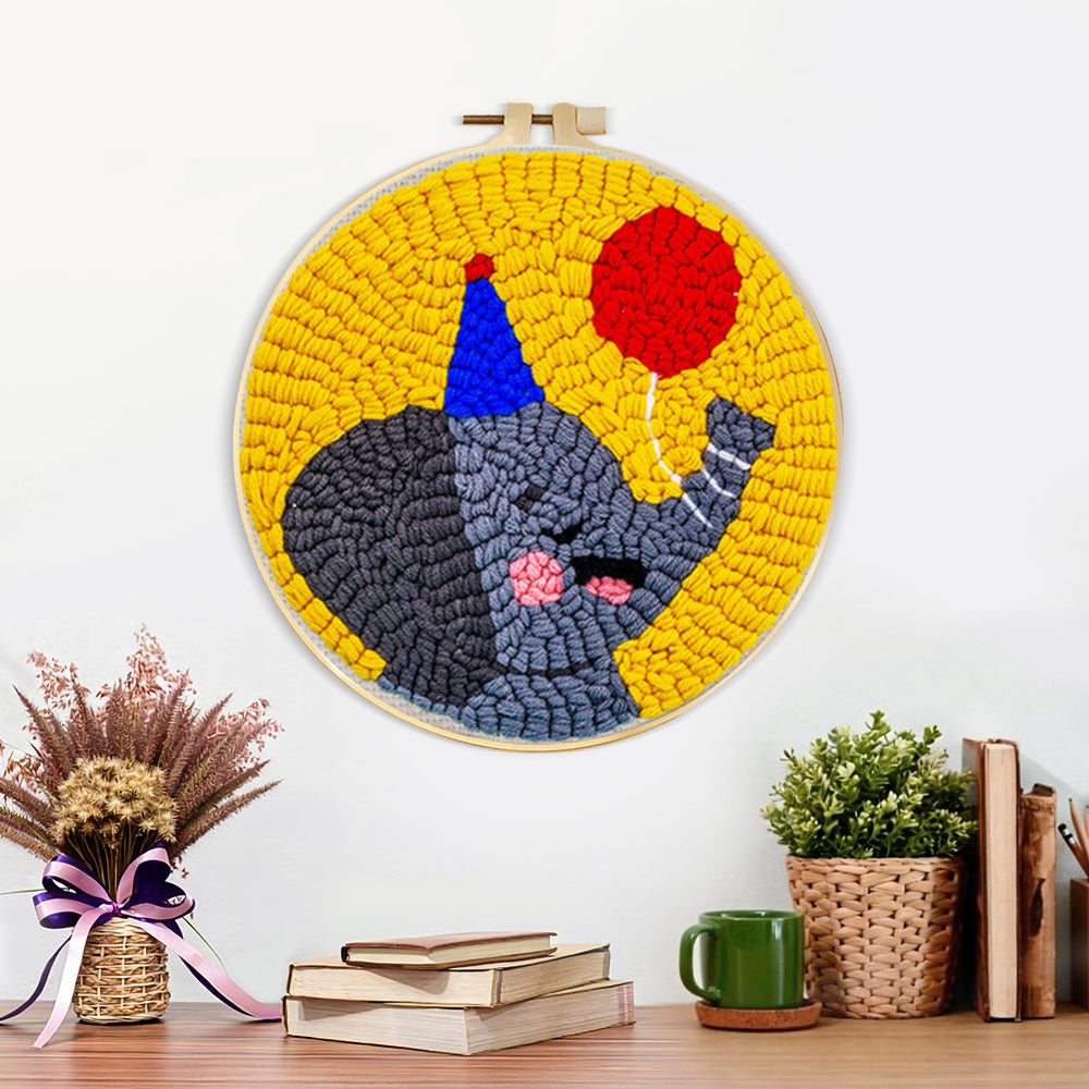 Finished happy elephant with a red balloon artwork displayed on a wall