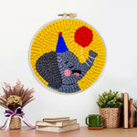 Finished happy elephant with a red balloon artwork displayed on a wall